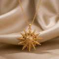 Gold Plated Silver Mintaka Star Pendant Necklace with a textured many-rayed pendant on champagne satin