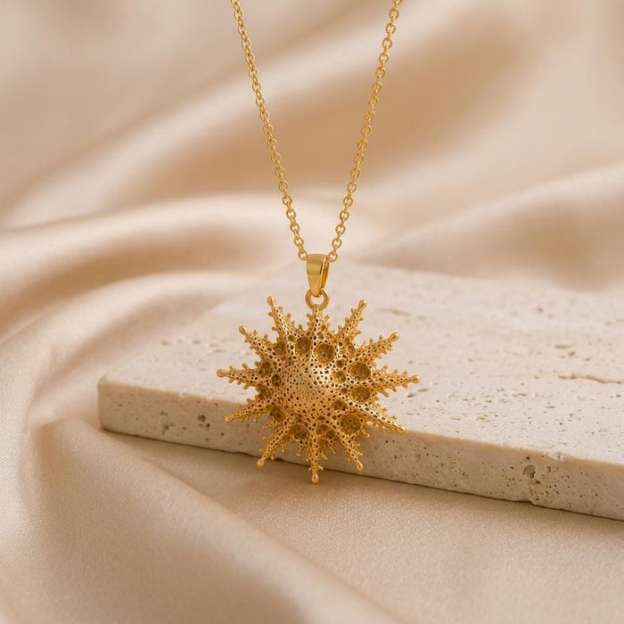 Gold Plated Silver Mintaka Star Pendant Necklace displayed above a pale stone block