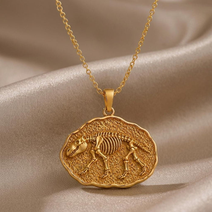 Gold-finish Moeritherium fossil pendant with raised skeleton relief on champagne satin