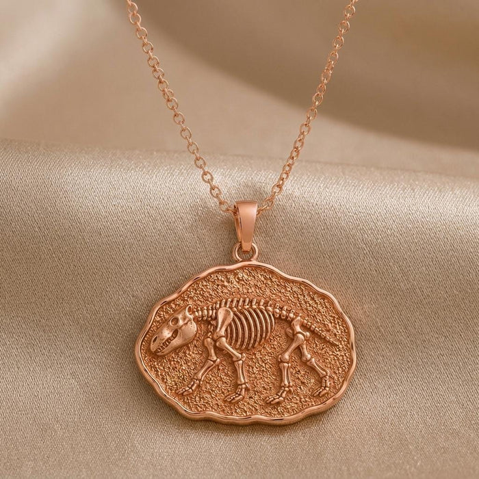 Rose Gold Plated Moeritherium fossil pendant with raised skeleton relief on satin