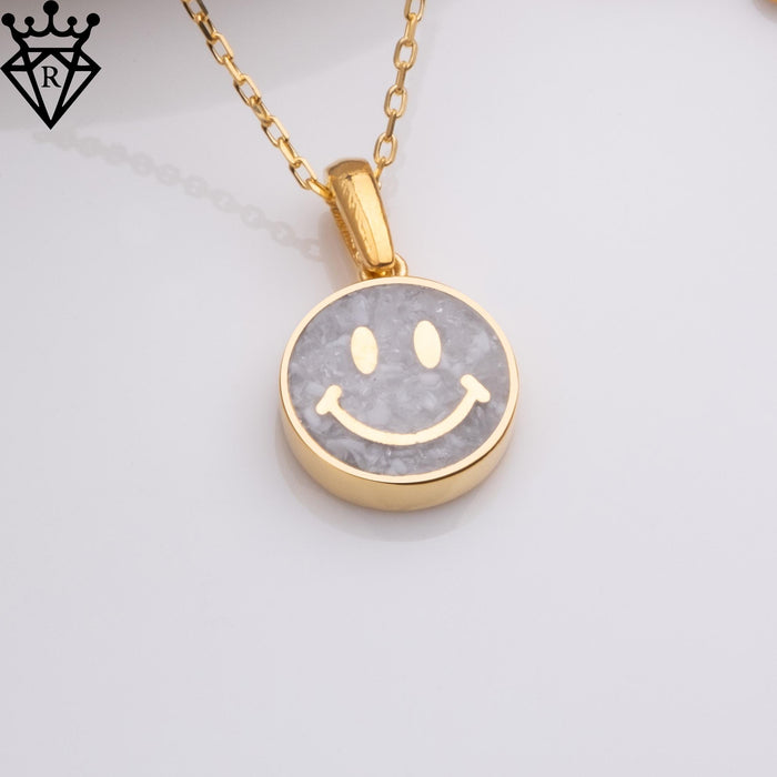 Close overhead product image of a round moonstone smiley pendant on a chain