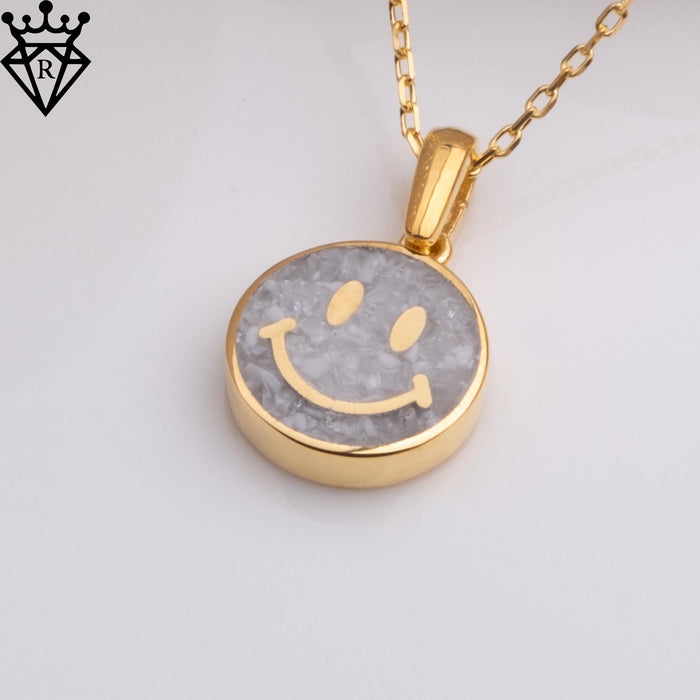 Angled close-up of the round moonstone smiley pendant and chain