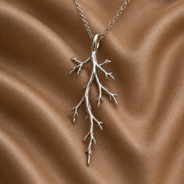 Silver Mystic Forest Branch Pendant Necklace with asymmetric twig-like offshoots on brown fabric