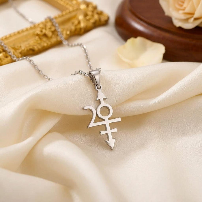 Nibiru symbol pendant on cream satin showing the open circular center and arrow points