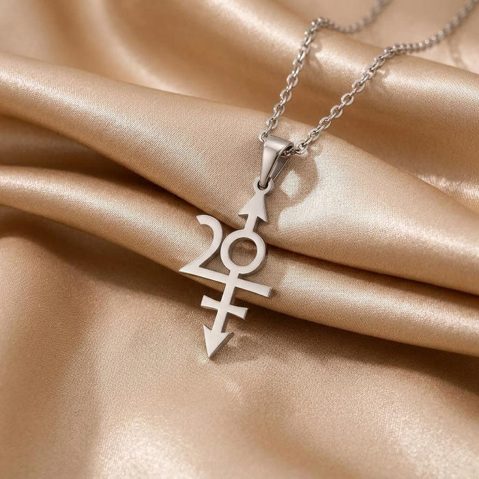 Close-up of the Nibiru symbol pendant on champagne satin with an open circular center and horizontal bars