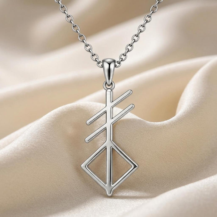 Close-up of the Silver Norse Creation Symbol pendant on ivory satin