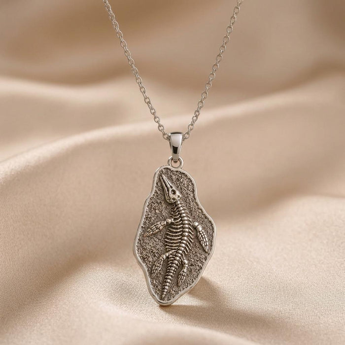 Silver Nothosaurus Fossil Pendant Necklace with raised skeleton design on a textured irregular plaque