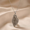 Silver Nothosaurus Fossil Pendant Necklace with raised skeleton design on a textured irregular plaque