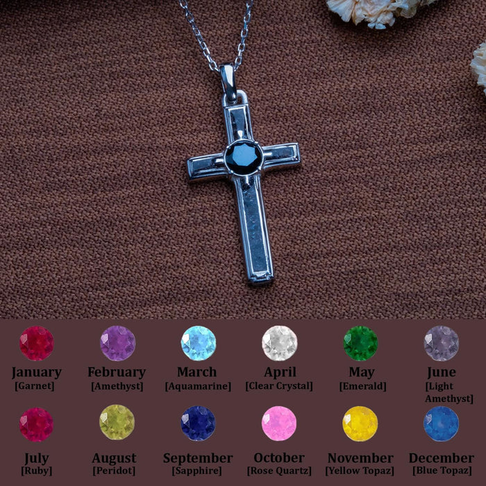 Onyx cross pendant necklace above a monthly stone personalization chart