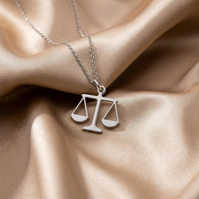 Openwork Scales of Justice Necklace arranged on champagne satin