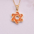 Orange agate interlaced six-point star pendant necklace with an open hexagonal center on pale fabric