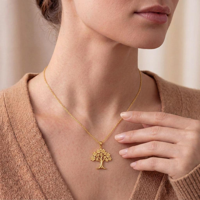 Gold Plated Silver Orchid Tree Pendant Necklace worn at the collarbone with a neutral knit top