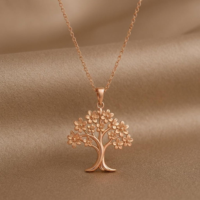 Rose Gold Plated Orchid Tree Pendant Necklace close-up on softly draped taupe fabric