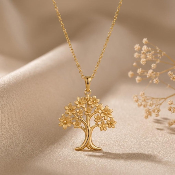 Gold Plated Silver openwork Orchid Tree Pendant Necklace styled on satin beside dried flowers