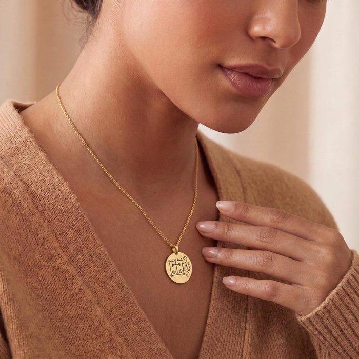 Gold Plated Silver Orobas Sigil Necklace worn with a brown knit cardigan