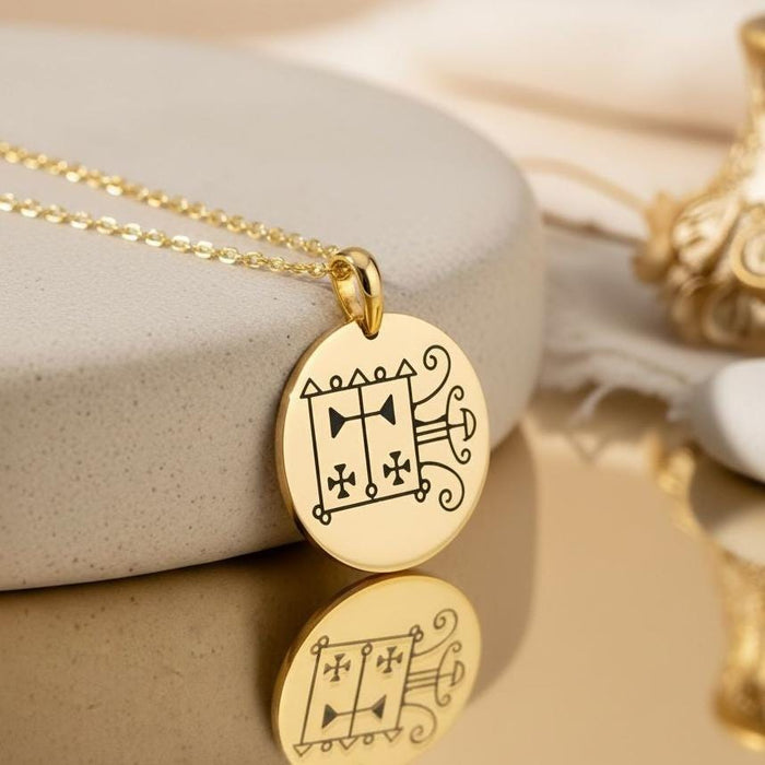 Gold Plated Silver Orobas Sigil round pendant close-up on a reflective neutral surface