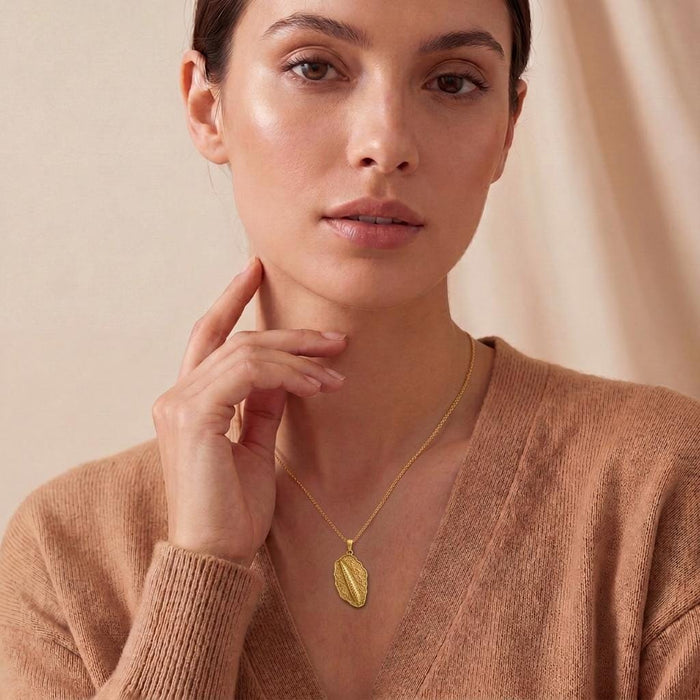 Front view of a model wearing a Gold Plated Silver Orthoceras Fossil Pendant Necklace