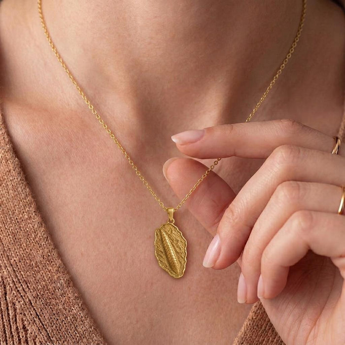 Close-up of a Gold Plated Silver Orthoceras Fossil Pendant Necklace worn at the neckline