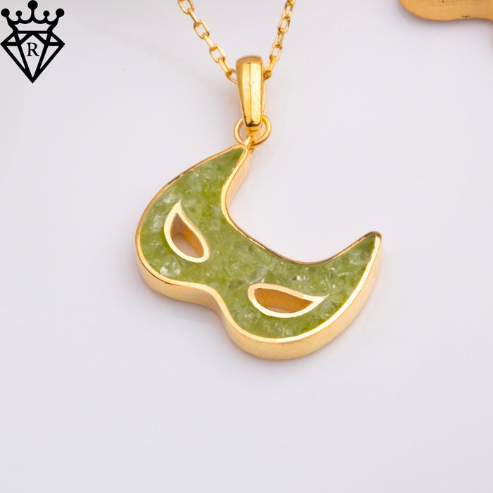 Close product image of a Gold Plated Silver mask pendant with a textured green center on a white background