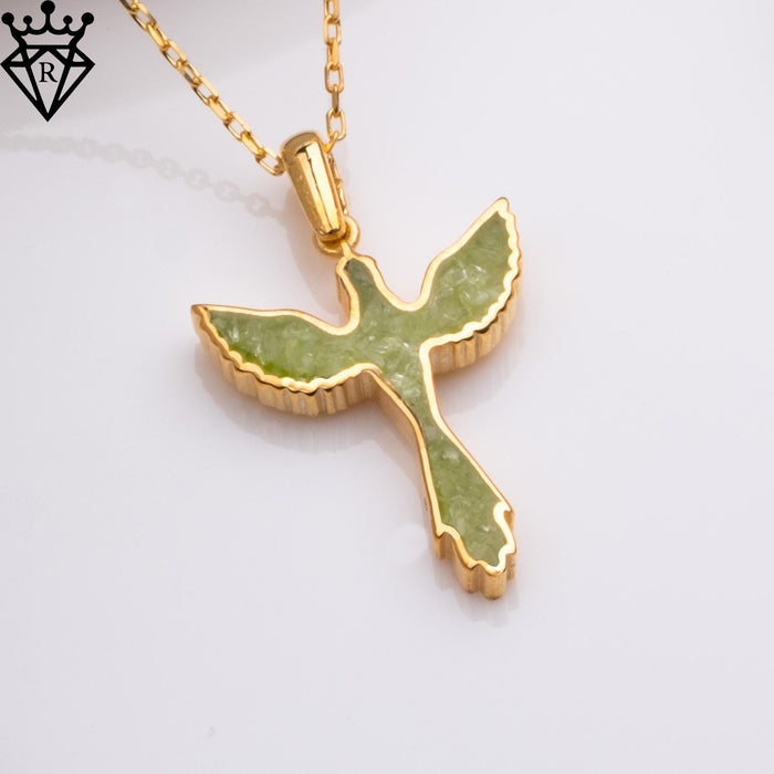Angled close-up of the green phoenix pendant on a gold-tone chain, showing the raised edge and scalloped wing shape
