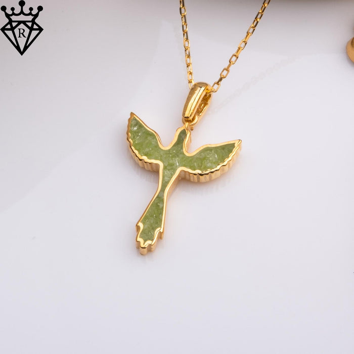 Scalloped wings and curved tail details of the phoenix-shaped pendant