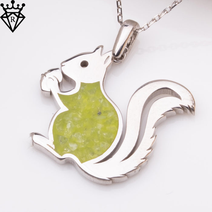 Close-up product photograph of the squirrel pendant showing the green body detail and curled tail