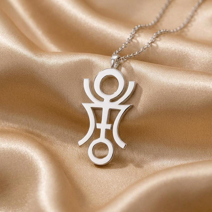 Close view of the Phaëton openwork symbol pendant on champagne-colored satin