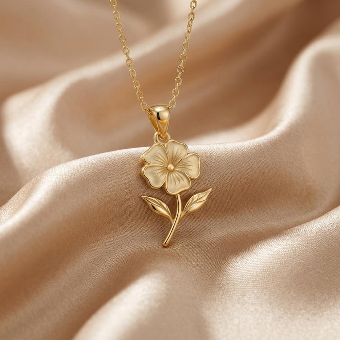 Close-up of a Gold Plated Silver five-petal phlox flower pendant on champagne satin