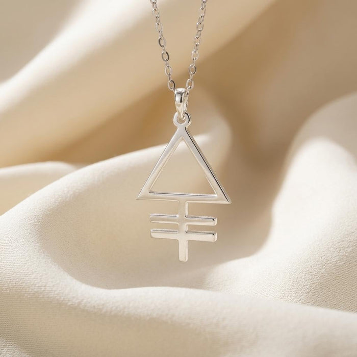 Phosphorus symbol pendant with two horizontal bars on draped cream fabric