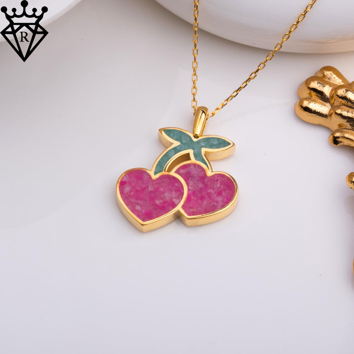Angled jewelry view highlighting the paired cherry setting and curved connecting stems