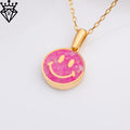 Close-up product photograph of the round pink agate smiley pendant on a Gold Plated Silver chain against a pale background, with a black crown-and-diamond logo watermark in th