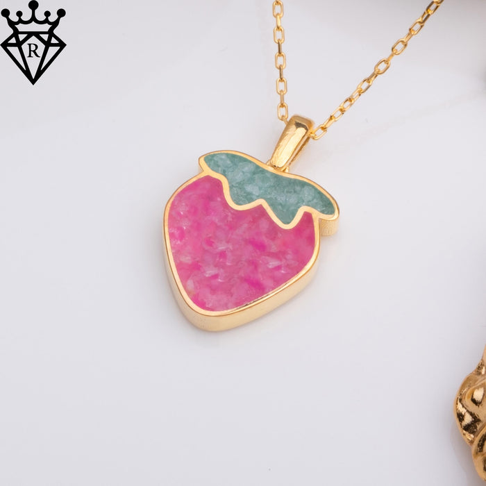 Angled strawberry charm showing its pink body and raised green leaf detail