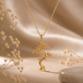 Gold Plated Silver Juniper Flame Pendant Necklace with textured tree on champagne satin and dried flowers