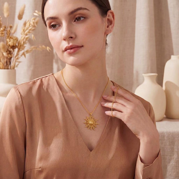 Gold Plated Silver Pollux Star Pendant Necklace worn with a beige V-neck blouse