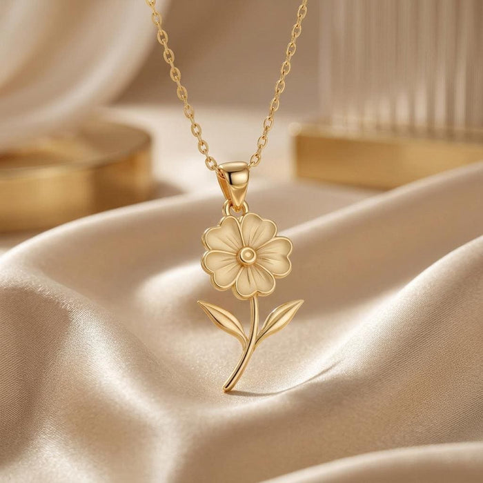 Gold Plated Silver Primrose Flower Pendant Necklace with outlined petals and curved stem on champagne satin