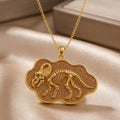 Gold Plated Silver Protoceratops Fossil Pendant with raised skeleton relief on champagne satin