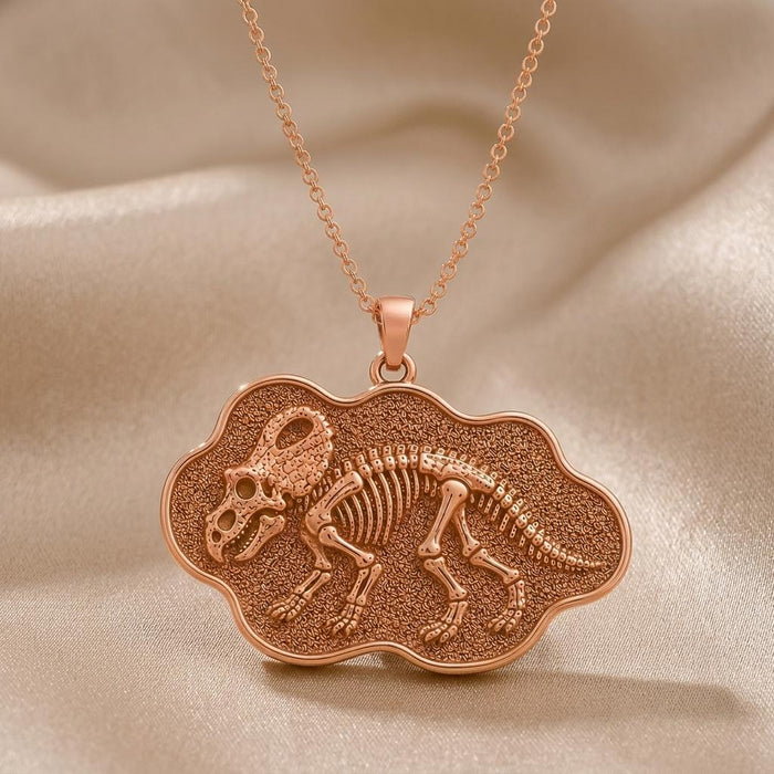 Rose-tone Protoceratops fossil plaque pendant on champagne satin