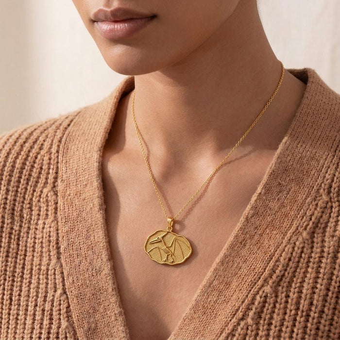 Close worn view of a Gold Plated Silver Quetzalcoatlus fossil pendant necklace