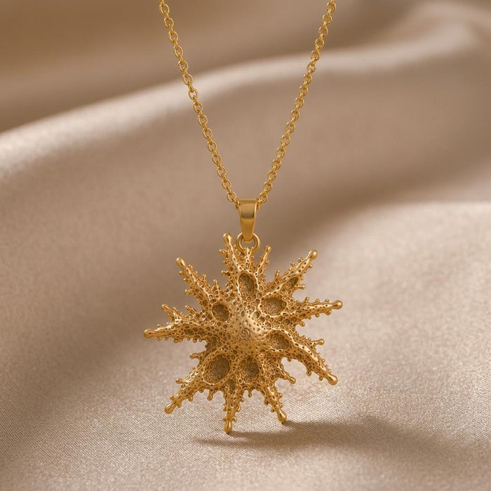 Gold Plated Silver Regulus Star Pendant Necklace with textured branching rays on champagne satin
