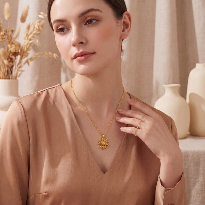 Model wearing a Gold Plated Silver Regulus Star Pendant Necklace with a satin blouse