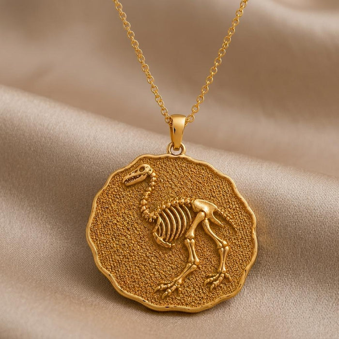 Gold Plated Silver Aepyornis Fossil Pendant Necklace with raised skeletal bird relief on a textured scalloped medallion
