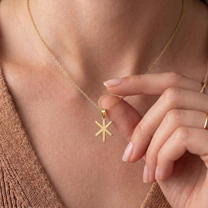 Gold Plated Silver Gebo Is bindrune necklace worn at the collarbone with the six-point pendant held in hand