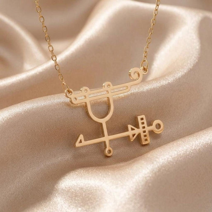 Gold Plated Silver Sabnock sigil pendant close-up on champagne satin