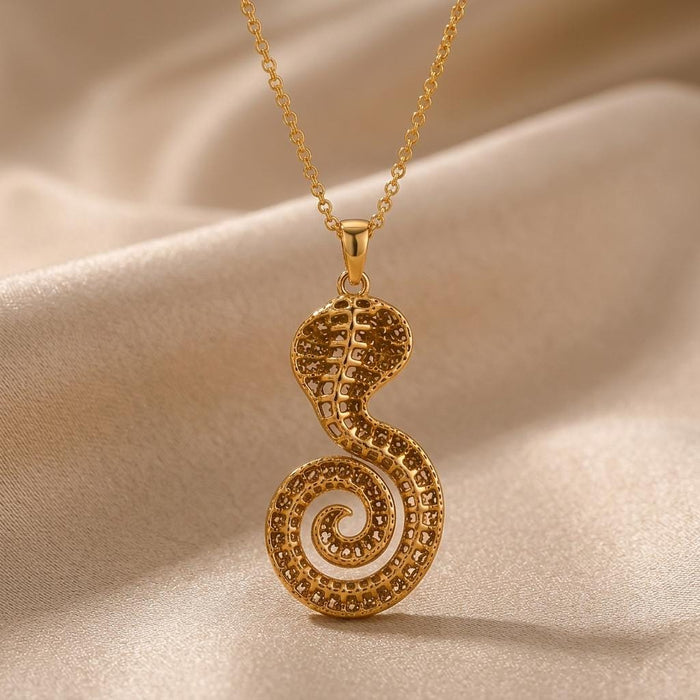 Gold Plated Silver Sacred Cobra Fossil Necklace with a raised cobra pendant and spiral tail on champagne satin