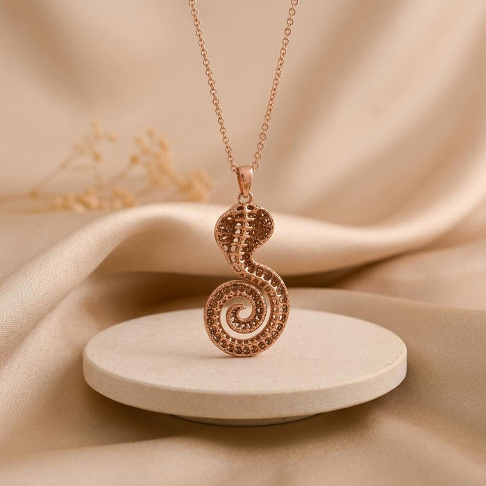 Rose Gold Plated Sacred Cobra Fossil Necklace with patterned openwork on a round stone pedestal