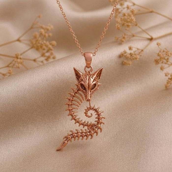 Rose Gold Plated Sacred Fox Skeleton Crest Pendant close-up showing the fox skull, rib-like arcs, and tapered tail