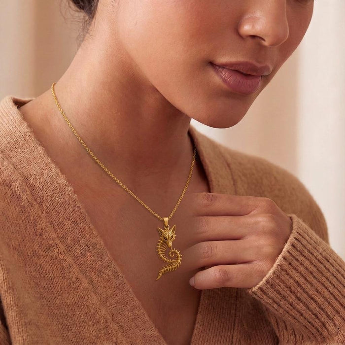 Gold Plated Silver Sacred Fox Skeleton Crest Pendant worn at the neckline with a textured knit top