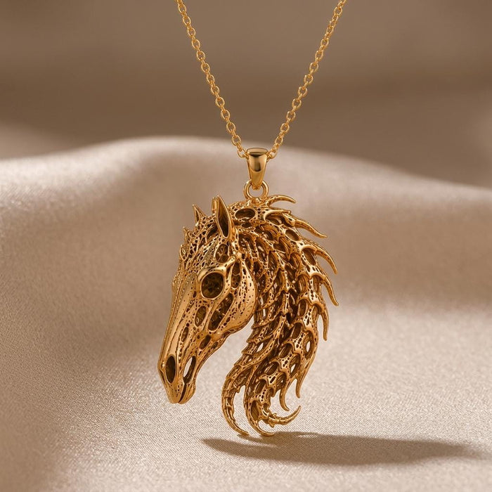 Gold Plated Silver Sacred Horse Skull Relic pendant with an elongated openwork skull and flowing mane on beige satin