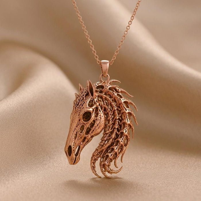 Rose Gold Plated Sacred Horse Skull Relic pendant with a layered openwork mane on draped beige fabric