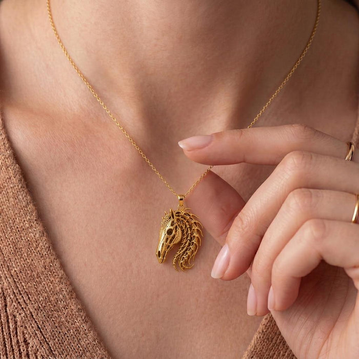 Close-up of a Gold Plated Silver Sacred Horse Skull Relic necklace worn at the neckline